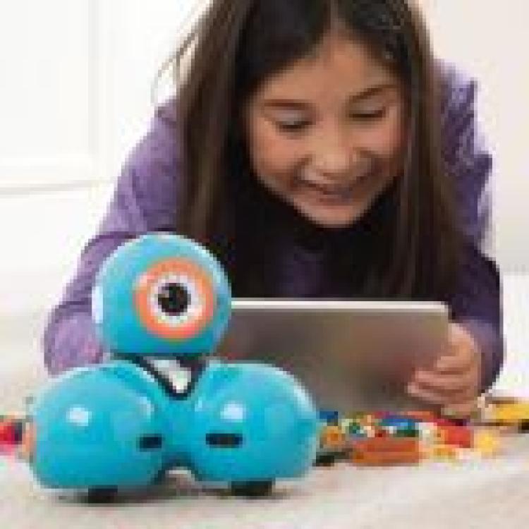 Girl playing with the Dash Coding Robot