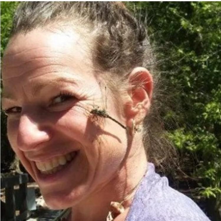 Jennifer Hammond smiling with a dragonfly on her cheek