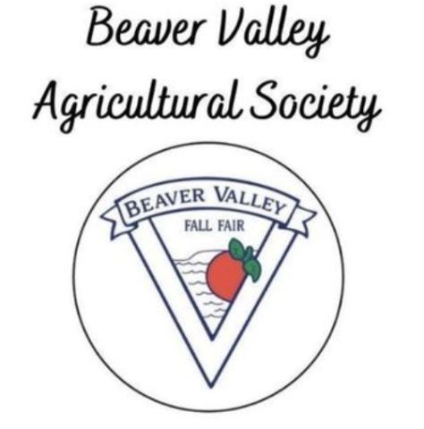 Written in cursive at the top of the image BEAVER VALLEY AGRICULTURAL SOCIETY. Below the the cursive writing is a black circle around the Beaver Valley Fall Fair logo of a banner on top of a large triangle that has a smaller triangle within it. In the smaller triangle are blue curving lines that represent waves, a blue out line of the Escarpment outcrop and a red apple with green stem and leaves in front of the waves. 