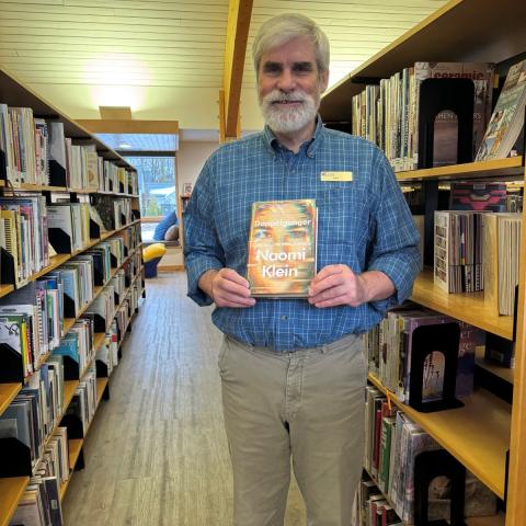 Ken holding Doppelganger by Naomi Klein