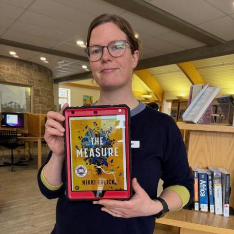 Sam holding The Measure by Nikki Erlich