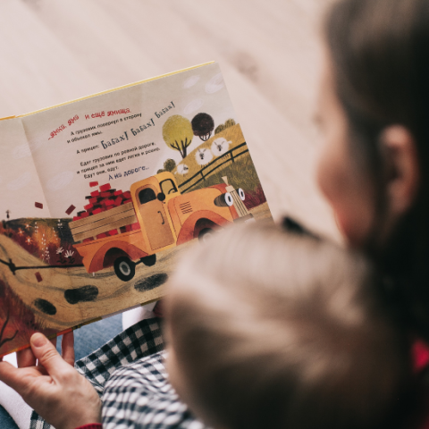 toddler and parent reading book together