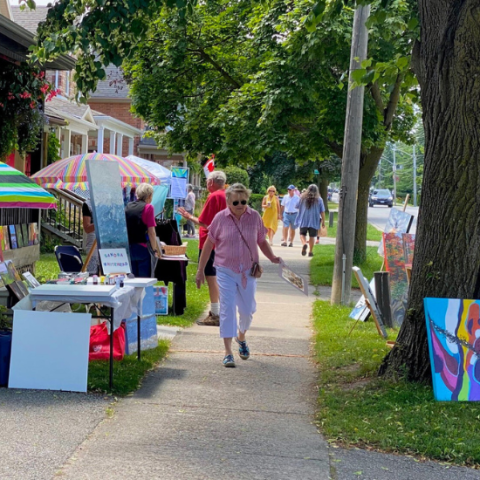 Lively street full of vendors and people enjoying art outside