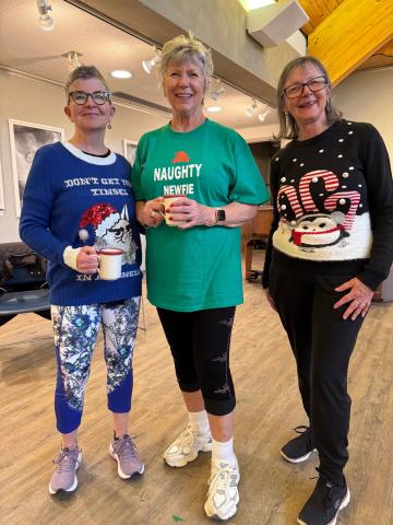 Instructors dressed in holiday sweaters