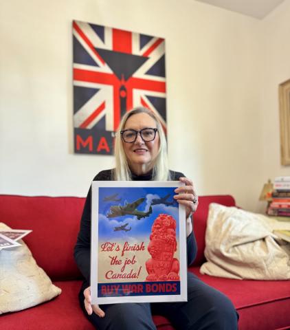Paula Hope holding a World War 2 poster