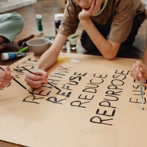 Kids creating waste reduction poster