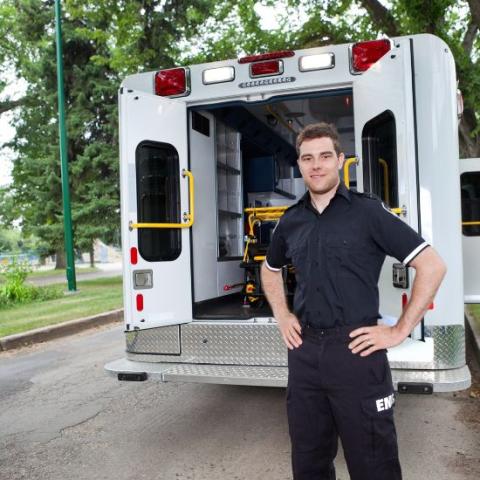 Paramedic standing outside ambulance